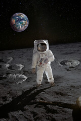 Astronaut on the moon surface with planet Earth behind. Elements of this image furnished by NASA.