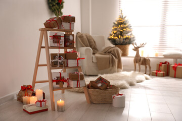 Advent calendar with gifts in room decorated for Christmas. Space for text