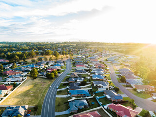 Sunflare of golden light over home owners properties in wealthy part of town