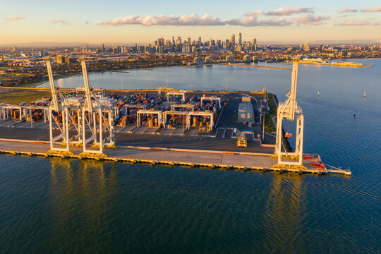 Aerial view of large gantry cranes sitting on the side of a loading dock