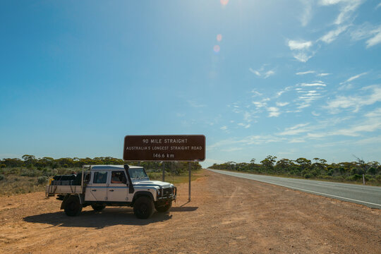 Ute parked in front of sign for Australia's longest straight road, Nullarbor, WA