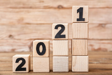 Cubes with 2021 on wooden background