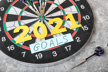 Figure 2021 with dartboard and text GOALS on grunge background