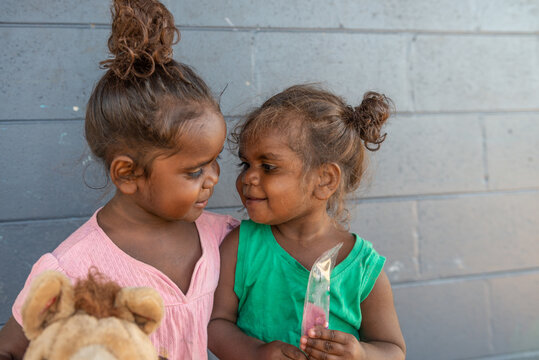 Aboriginal sisters looking at each other affectionately