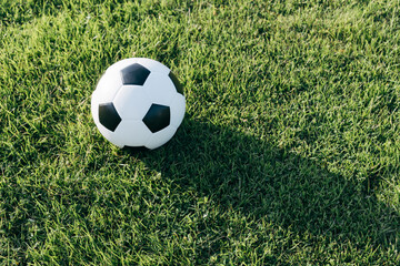 Fototapeta na wymiar Soccer ball on grass field, sport concept.