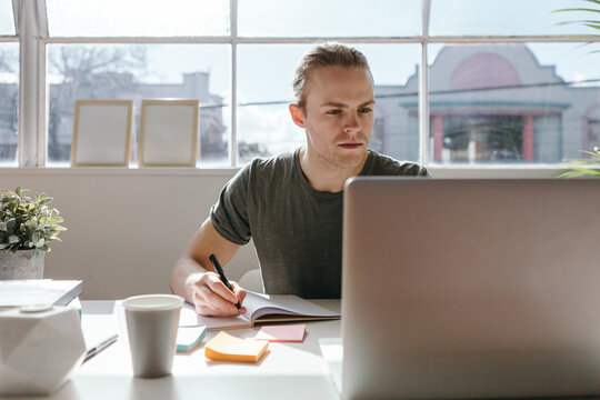 Creative employee at work with a laptop in the foreground
