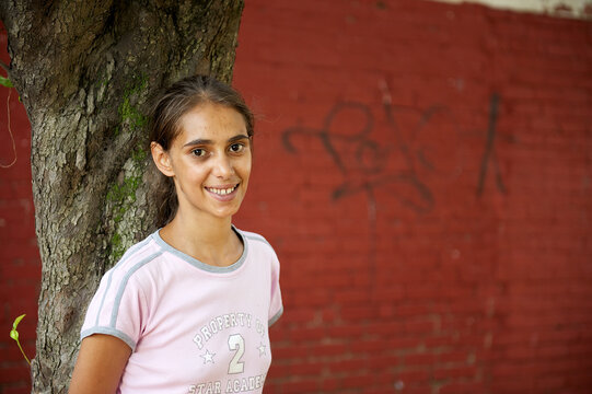 Young Aboriginal Woman with Red Wall in Background