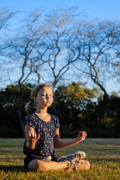 Young girl meditating in the park