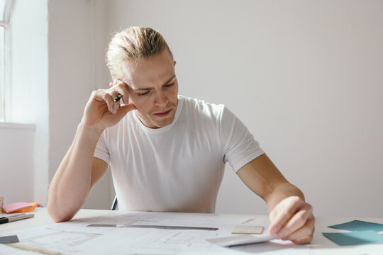 Man frowning and deep in thought at work