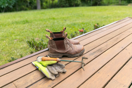 Gardening fork, gloves and boots on verandah