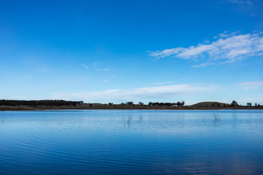 water in reservoir under blue sky