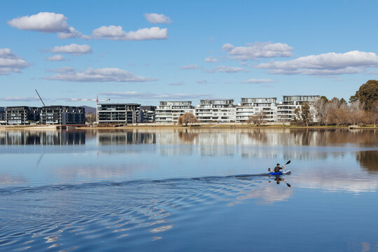 A kayaker glides across Lake Burley Griffin in Canberra
