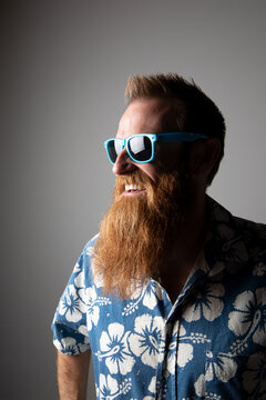 Funky man in a blue floral shirt posing for photographs