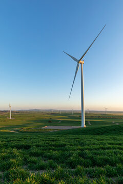 wind tower with wind farm in distance - vertical