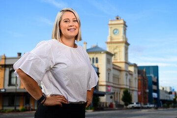 Confident young caucasian woman in main street of rural town