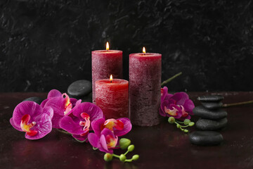 Beautiful spa composition with aroma candles on dark background