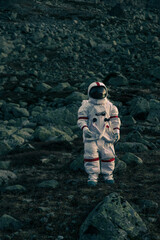 Astronaut exploring a new planet. Searching for a new home for humanity. Concept about science and...