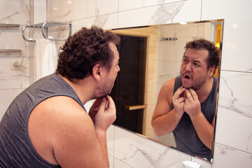Morning. Funny fat man in pajamas in the bathroom.
