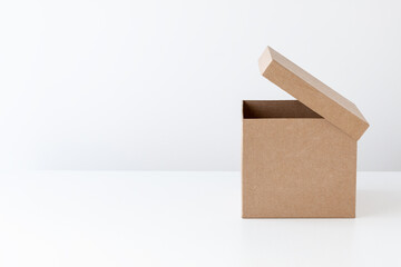 Half-open cardboard box on a white background. Side view. Place for text. - 394742683