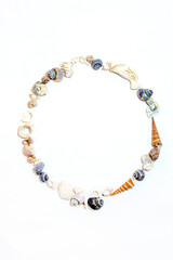 Сircle of small marine colored orange blue pink purple seashells of different shapes on white background. Vertical Design template