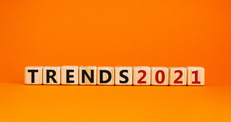 Business concept of starting 2021. Wooden cubes with words 'Trends 2021'. Beautiful orange background, copy space. Trends 2021 and new year concept.