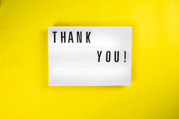Thank You! text on lightbox on yellow background isolated. Top view, flat lay, thanks of heroes, thanking doctors, nurses and medical staff working in hospitals during COVID-19 coronavirus pandemic