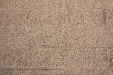 Fototapeta premium Tan brick wall great for backgrounds, textures and design elements.
