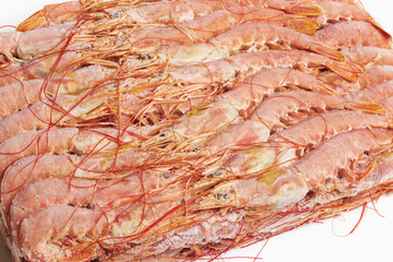 Large fresh frozen langoustines are beautifully arranged on a white background