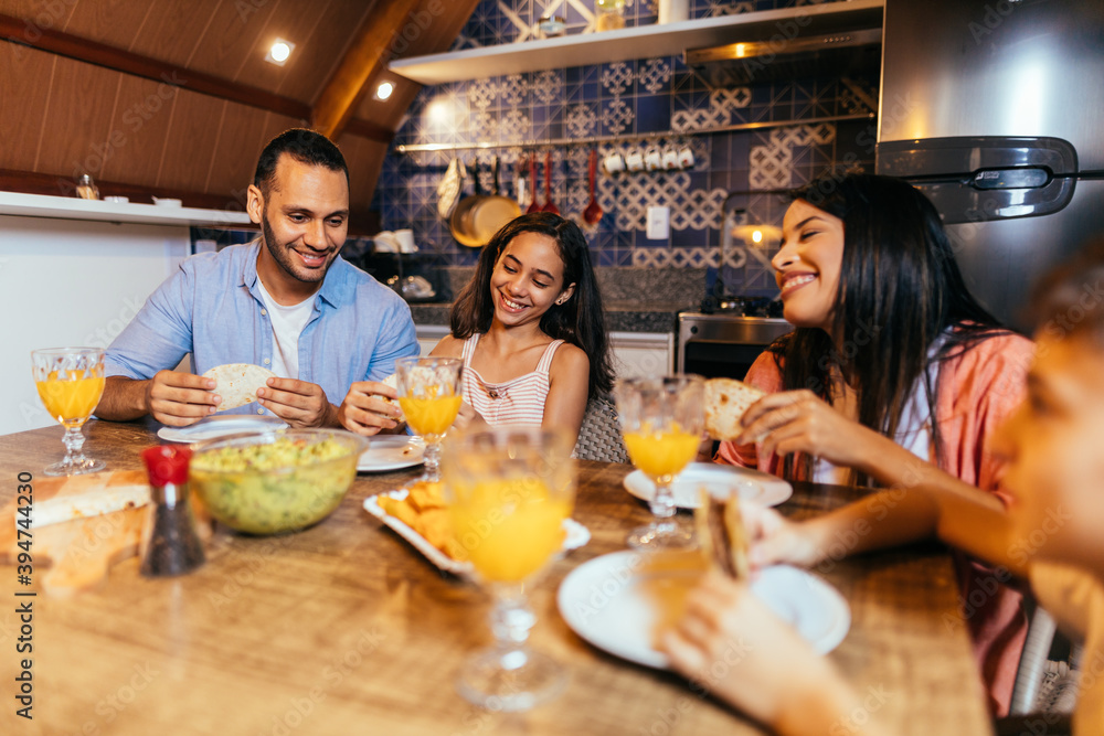 Wall mural latin family having dinner at home