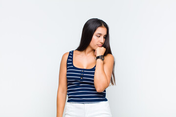 young woman feeling bored, frustrated and sleepy after a tiresome, dull and tedious task, holding...