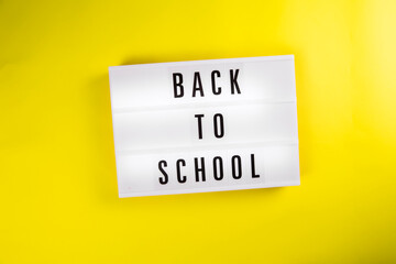 Back to school message on lightbox on yellow background isolated. Unschooling, Home Learning, Home school, Homeschooling, Home Education, studying home, learning method concept