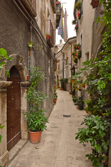 Fototapeta na wymiar A narrow street among the old houses of Pacentro, a medieval village in the Abruzzo region.