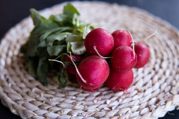 Bunch of organic red radishes with green leaves. 