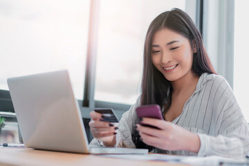 Asian woman shopping online retail store ecommerce using credit card debit card mobile smartphone smart payment transaction money cash transfer technology purchasing product beautiful happy smiling
