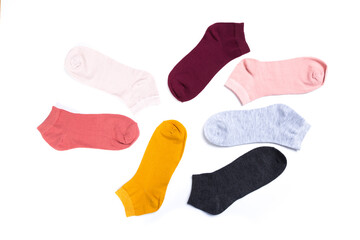 several colored new short socks on a white background, top view