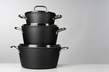 New domestic cookware on grey background close up