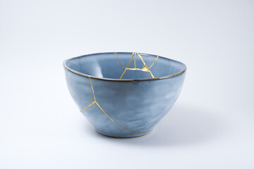 Blue kintsugi bowl. Gold cracks restoration on pottery restored with the antique Kintsugi...