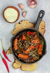 Roast meat (pork, beef) with bracken fern, onion, garlic, chili pepper and sesame seeds. Traditional dish of East Asian cuisine (China, Korea, Japan). Delicious gourmet dinner. Selective focus