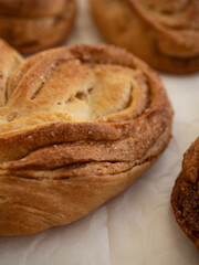 Homemade sweet bun with cinnamon and sugar on white paper background