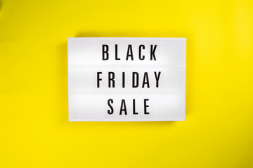 Black Friday Sale message on lightbox on yellow background isolated. Concept Black friday, season sales time. Sales, special offers, discounts, elimination of last year's collection concept