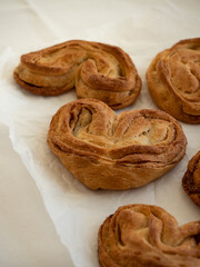 Homemade sweet bun with cinnamon and sugar on white paper background