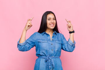 young woman crossing fingers anxiously and hoping for good luck with a worried look