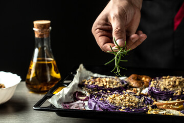 Closeup image of a chef cooking autumn dish of red cabbage baked with nuts, quince and apples, Vegan roasted red cabbage steaks, Food recipe background. Close up