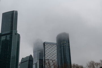 Fototapeta na wymiar mesmerizing geometry of skyscrapers receding into the clouds against a gray sky