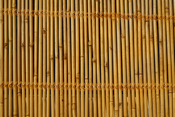 Wall of bamboo. The texture of bamboo. The stems are tightly woven.