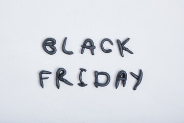 the inscription black friday from plasticine on a gray background