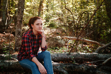 traveler hipster woman standing alone in autumn woods .