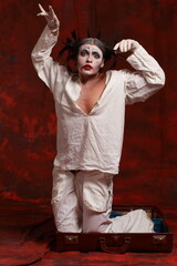 The art of depression. Studio portrait of young female model performing as an old clown suffering from pandemic lockdown and isolation. Pandemic stress conception