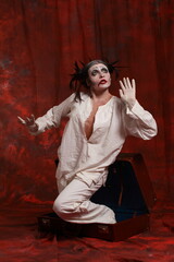 The art of depression. Studio portrait of young female model performing as an old clown suffering from pandemic lockdown and isolation. Pandemic stress conception