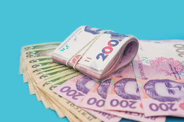 Ukrainian hryvnia on a blue background. Banknotes of 200 and 500 hryvnia.